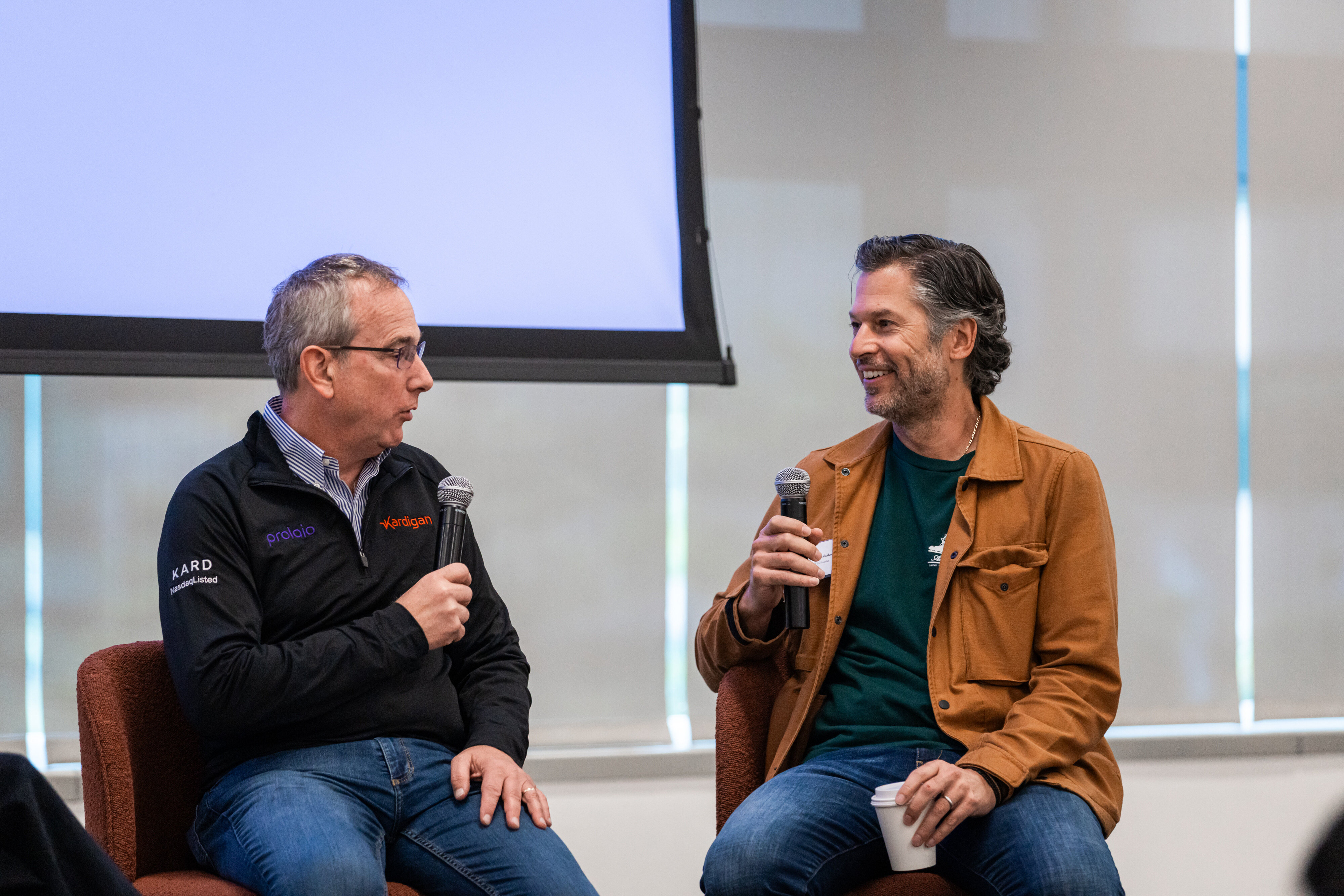 Prolaio founders Tassos and Jay on stage